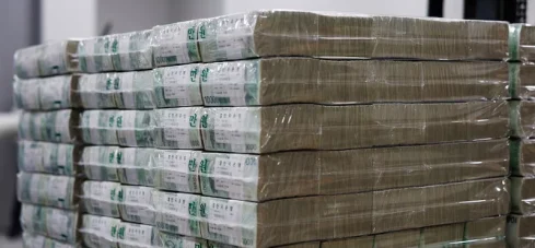 Billetes surcoreanos de 10.000 wones preparados en la sede del Banco de Corea (BOK) apilados e un contenedor.